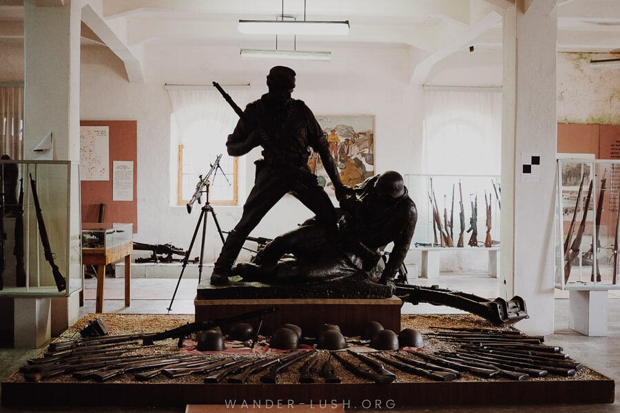 A statue of two soldiers inside a Military Museum in Albania.