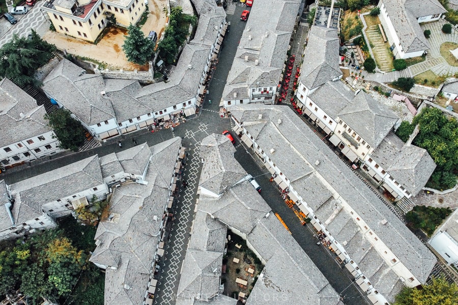 An aerial view of the Gjirokaster Bazaar, with grey rooftops and a decorative pavement design.