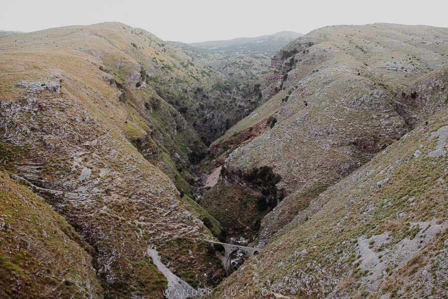 Rolling hills and a stone bridge.