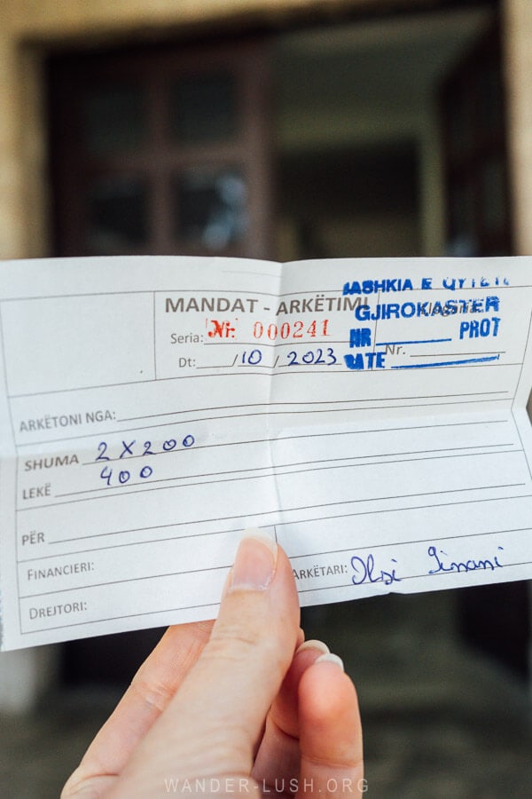 A woman holds a ticket for the bunker museum in Gjirokaster Albania.