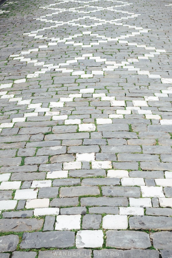 White and grey cross-hatch pavement design inside the Gjirokaster Old Bazaar.
