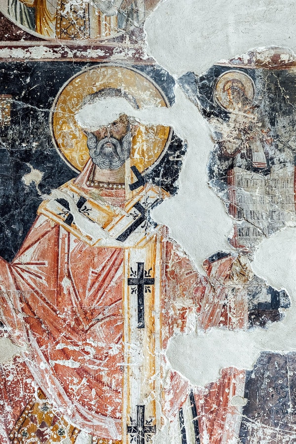 Orthodox icon paintings on a wall inside a historic Byzantine church in Albania.