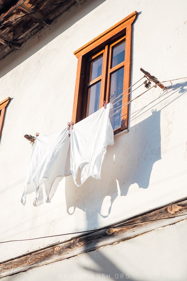 White laundry hanging on a washing line on a historic house in Berat in Albania.