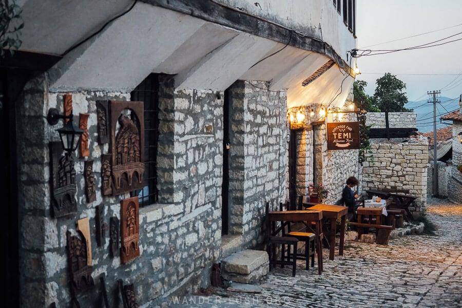 A small restaurant inside Berat Castle called Temi Albanian food, with tables set out on the cobbled street.