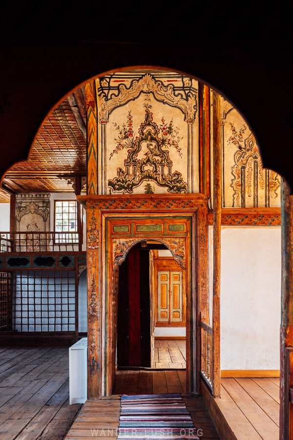 Looking through a doorway at a painted room inside the lavish Tsiatsiapas Mansion in Kastoria.