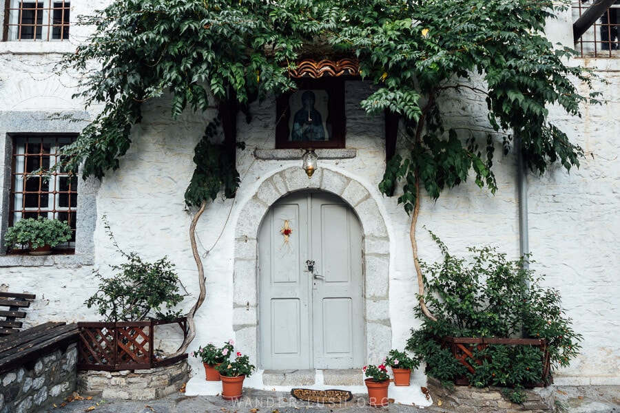 The Holy Church of Saint Paraskevi of Dragota in Kastoria, with its green doorway surrounded by leafy vines.