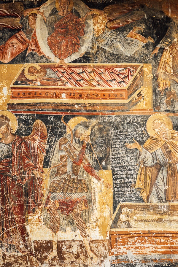 Old frescoes inside a church in Kastoria, damaged by scratches.