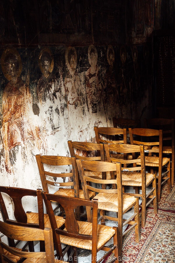 Wooden chairs arranged inside a small Byzantine church in Kastoria, Greece.