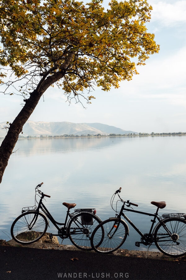 Two bicycles by the side of the road overlooking Lake Orestiada in Kastoria.