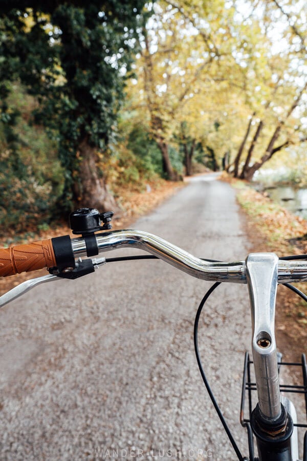 View of a path around Lake Orestiada from behind a bicycle.