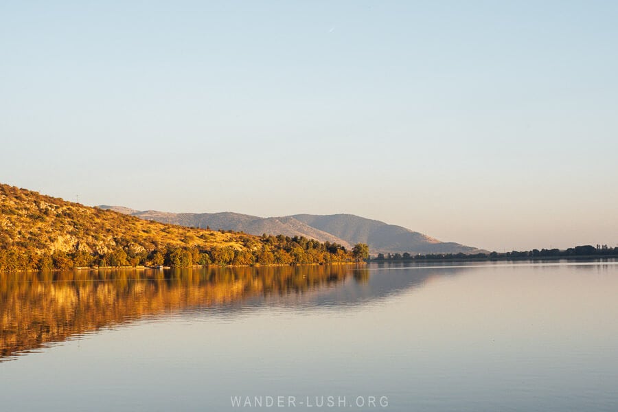 Sunset on Lake Orestiada, with the trees turned flame coloured from the setting autumn sun.