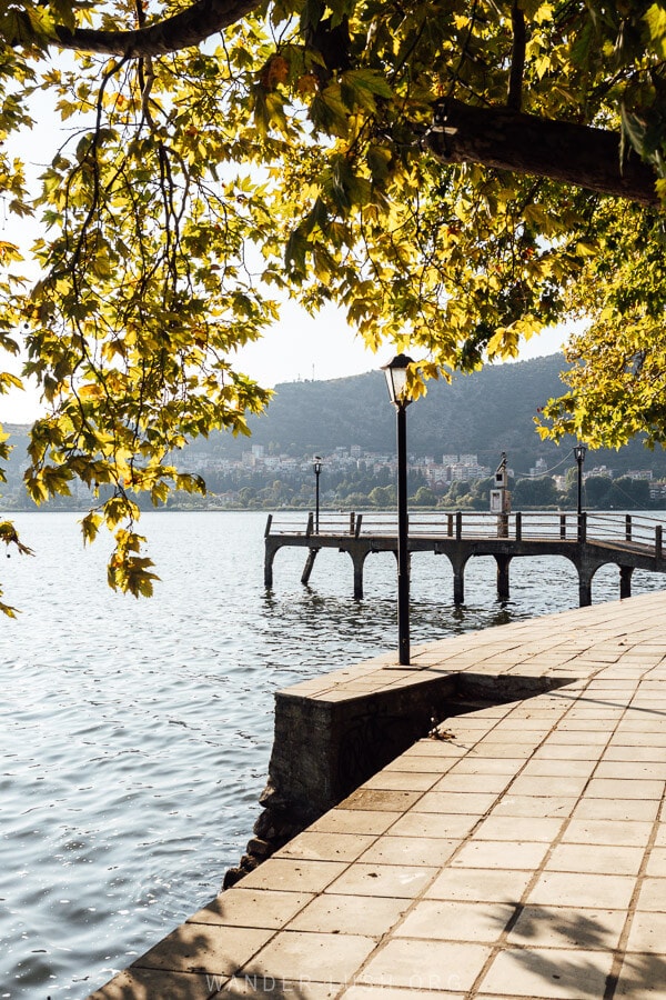 A jetty shrouded with fall leaves on the edge of Kastoria's Lake Orestiada.