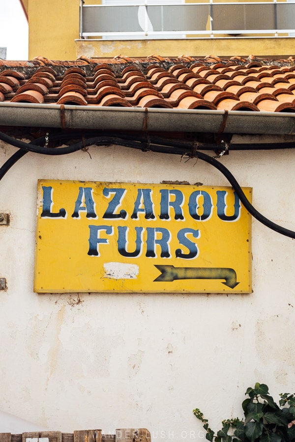 A yellow sign that reads Lazarou Furs.