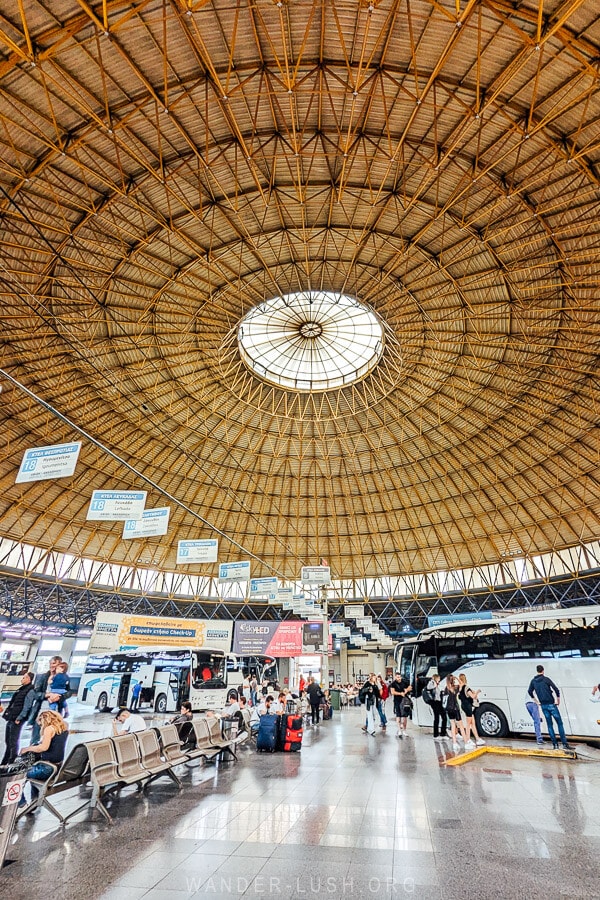 Buses wait under a round roof at Thessaloniki bus terminal.