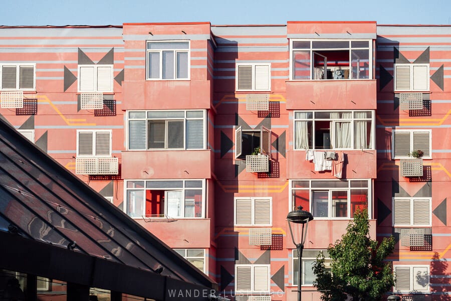 Colourful apartment buildings painted pink and yellow in downtown Tirana, Albania.