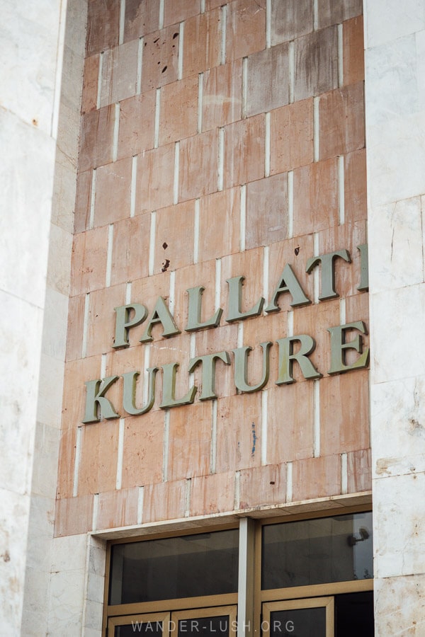 The stone sign for the Palace of Culture in Tirana.