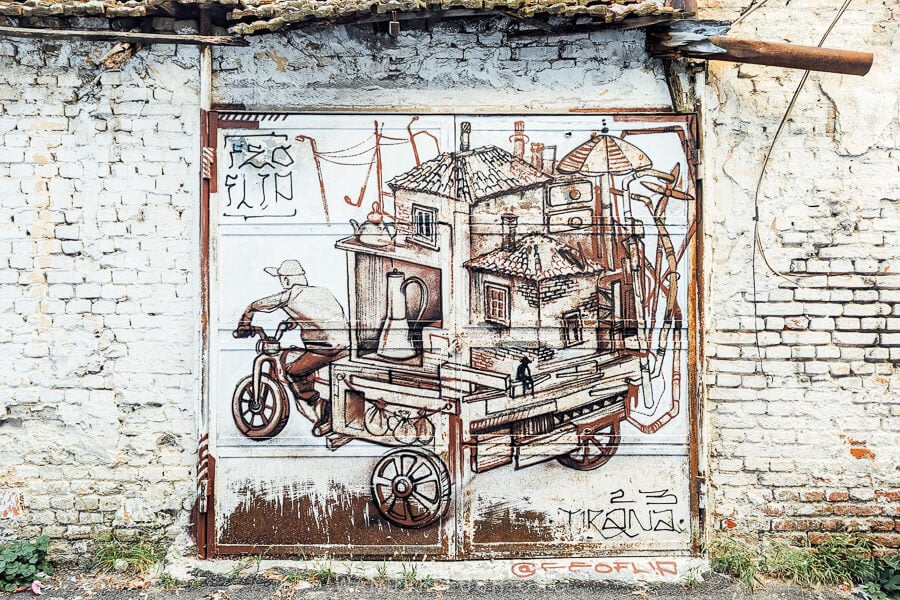 A piece of street art in Tirana, Albania feature an old-school coffee vendor.