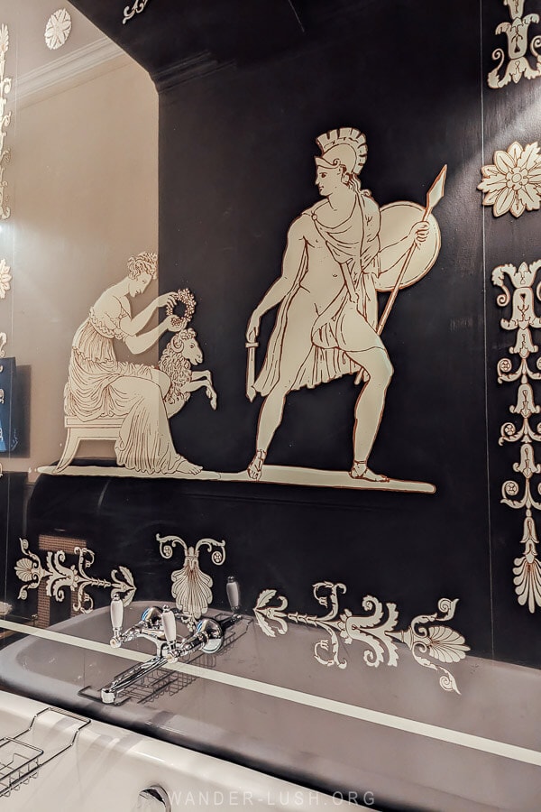 A glass frieze of Jason and Medea above a clawfoot bathtub at a boutique hotel in Kutaisi, Communal Kutaisi.