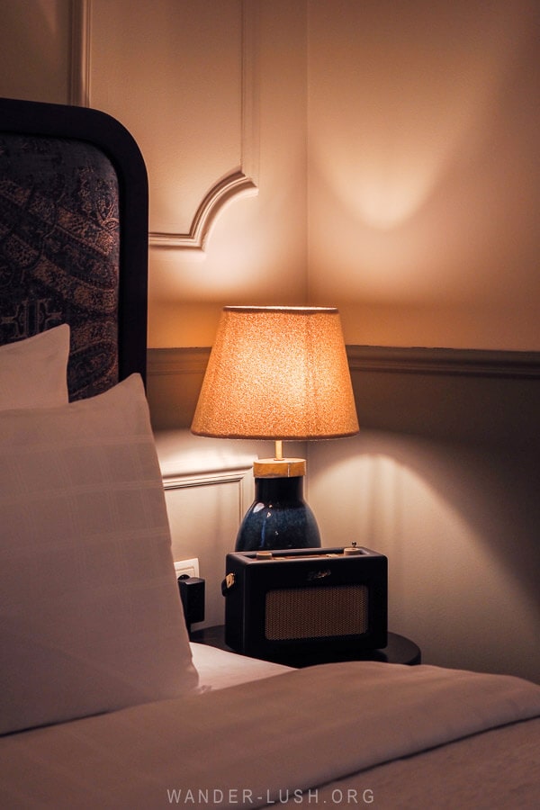 A lamp and radio on a bedside table at Communal Kutaisi boutique hotel.