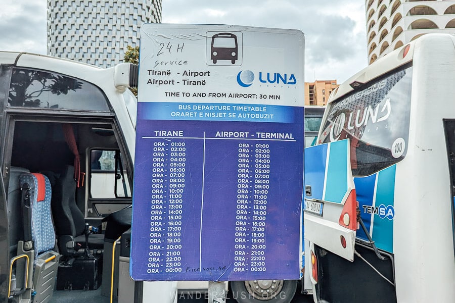 Bus times for the Tirana Airport Bus, a schedule posted on a sign at the bus station.