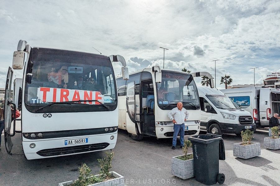 Large coach buses waiting for passengers at Tirana Airport.