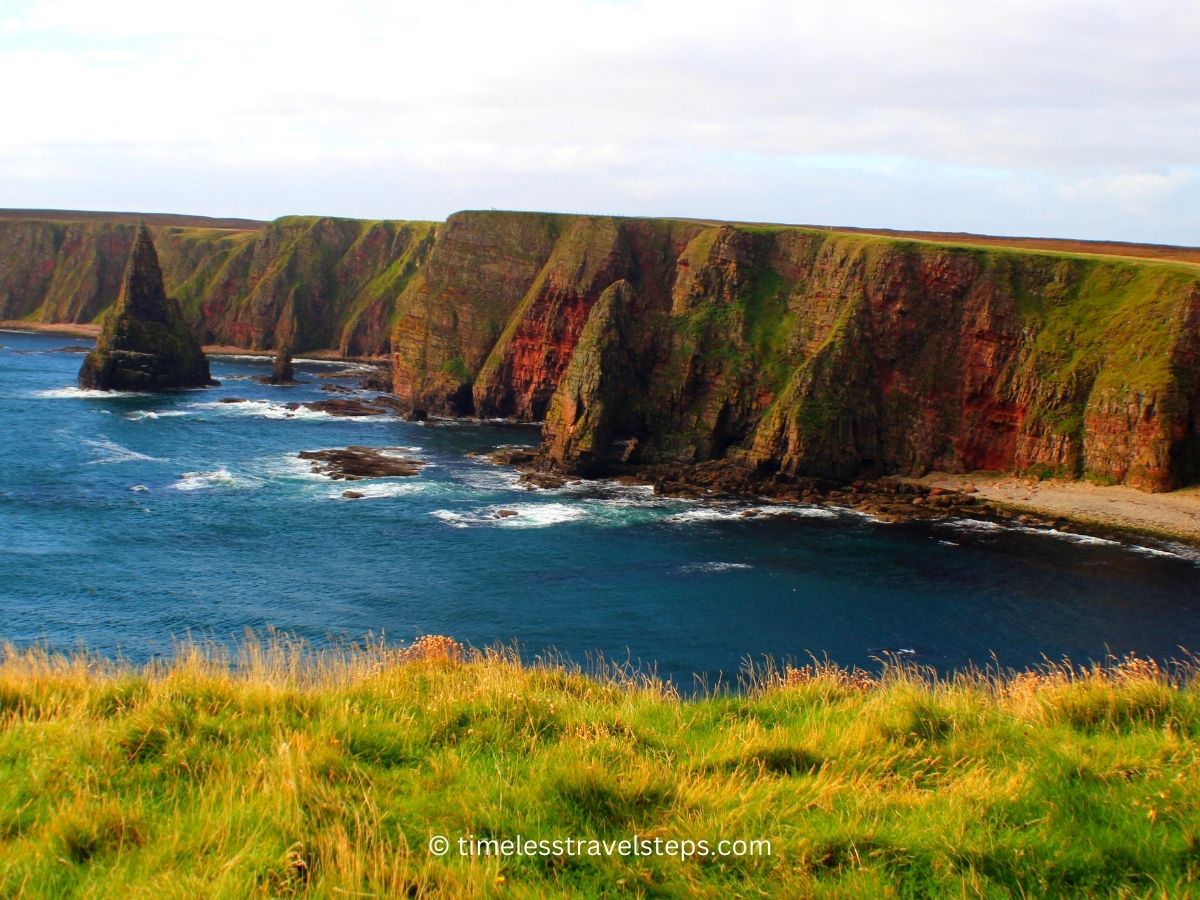 scenic view of water lashing at the majestic duncansby stacks viewed from the clifftop walk 