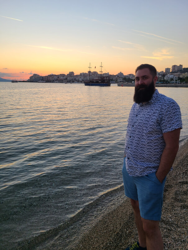 Jason poses on the beach in Saranda as the sun sets. Our first week in Albania for our gap year