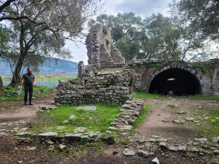 A sunken roman merchant house at Butrint National Park. A large doorway just barely pops up over the ground