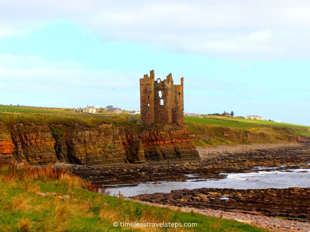 Keiss Castle perched on the cliff overlooking Sinclair's Bay of the North Sea