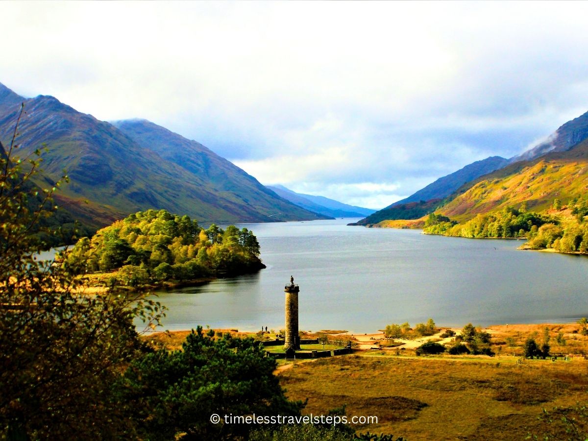 Glenfinnan Monument overlooking the serene and picturesque Loch Shiel © timelesstravelsteps.com