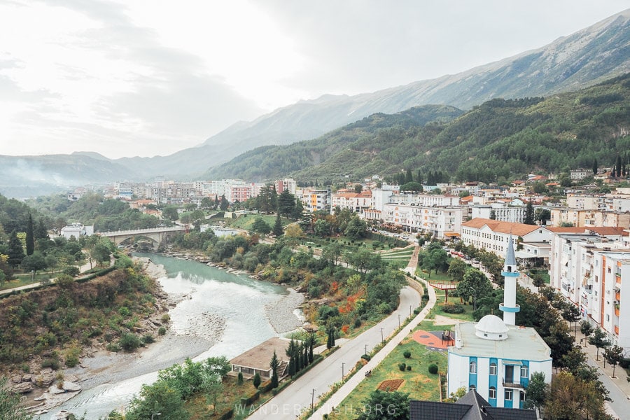 View of Permet, a city of apartment blocks and a mosque on the banks of the Vjosa River in Albania.