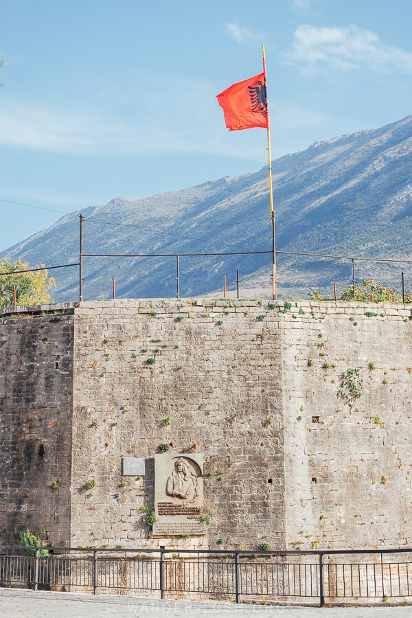 An Albanian flag flies above the Tepelena Castle in Albania.