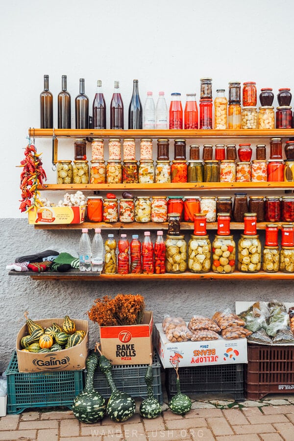 Jars of pickles and gliko jams for sale at a street market in Lin, Albania.