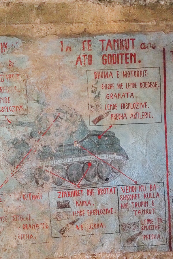 Grafitti artwork inside a bunker in Albania depicting tanks and weapons.