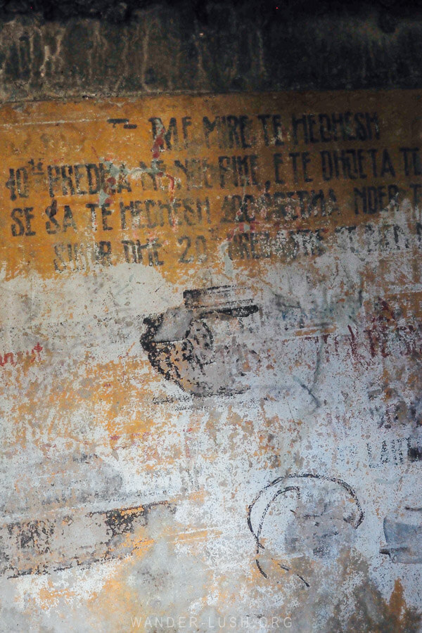 Grafitti artwork inside a bunker in Albania depicting tanks and weapons.