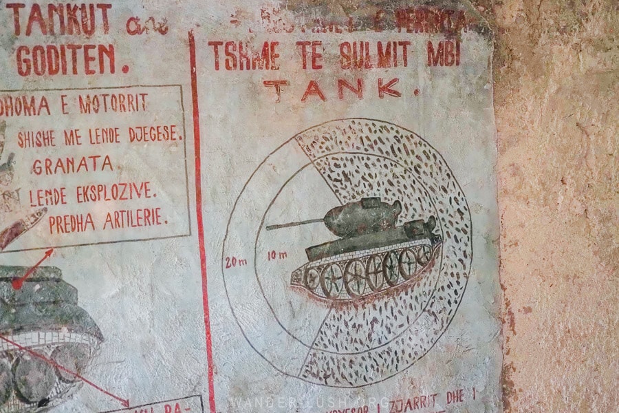 Grafitti artwork inside a bunker in Leskovik, Albania depicting tanks and weapons.