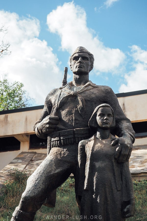 A war memorial in Erseke, Albania depicts a solider with his hand on a young girl's shoulder.