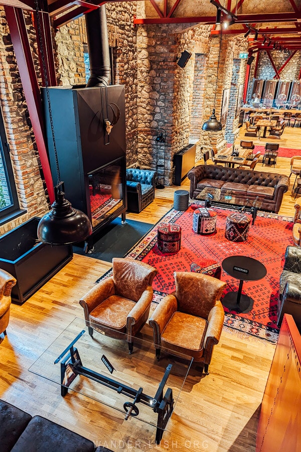 The lounge at Melesin Distillery in Leskovik, with Albanian carpets and an open fire.