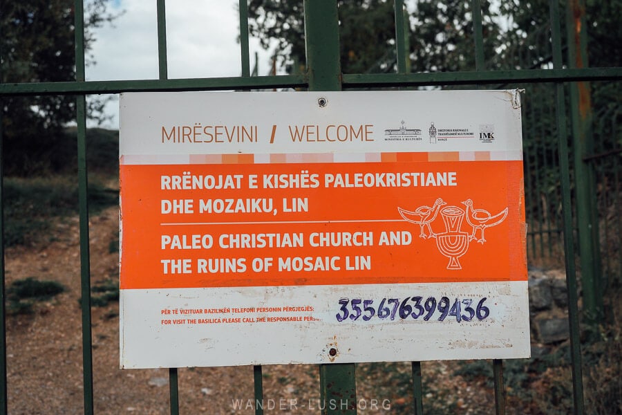 A sign welcomes visitors to the Mosaic of Lin in Albania.