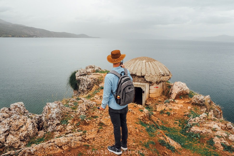 A man photographs the Lin Bunker overlooking Ohrid Lake.