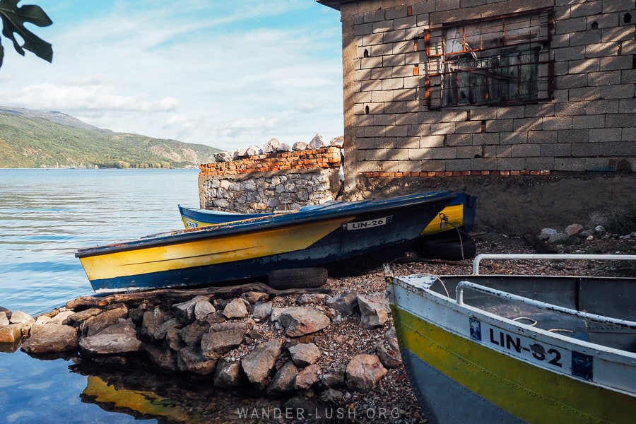 Fishing boats pulled onto the rocky shore in Lin, Albania.