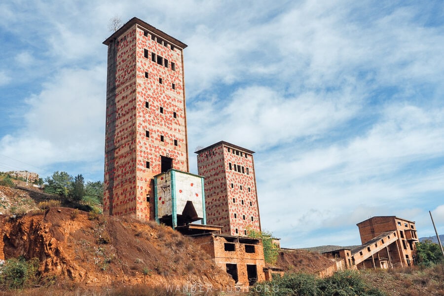 Abandoned industrial buildings in the Albanian town of Prrenjas painted with ladybug designs.