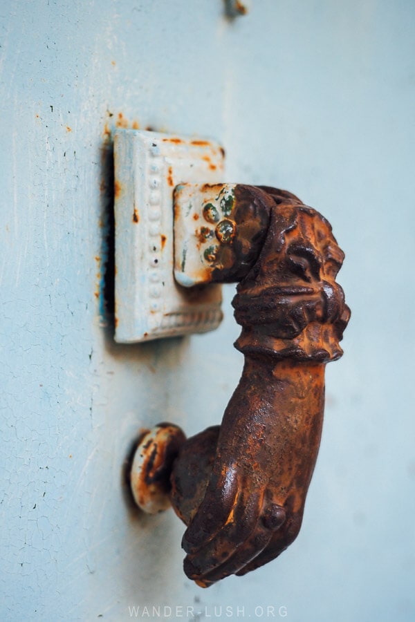 A rusted hand of Fatima door knocker seen in a small village in Albania.