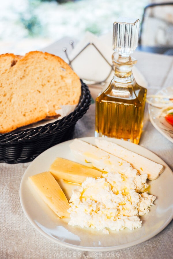 A plate of local cheese served with bread and olive oil at a family restaurant in Qeparo, Albania.