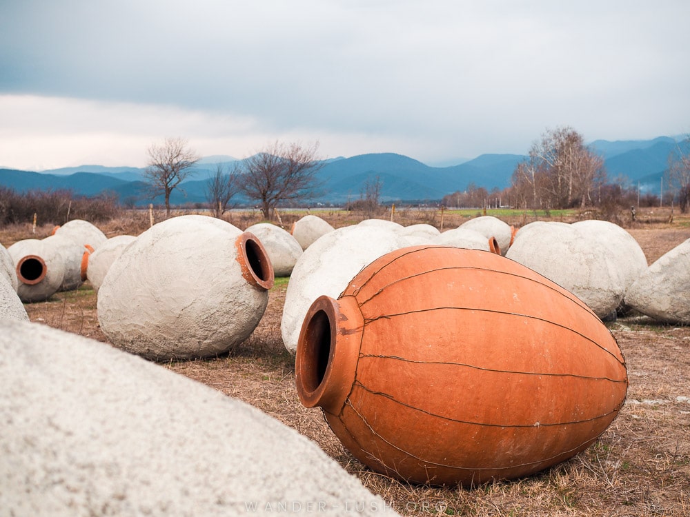 A set of clay qvevris on a field in Kakheti, Georgia.