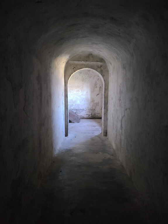 A dark hallway with light at the end at Gjirokaster castle