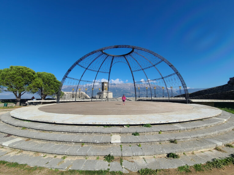 A big round stage with the mountains behind at Gjirokaster Castle