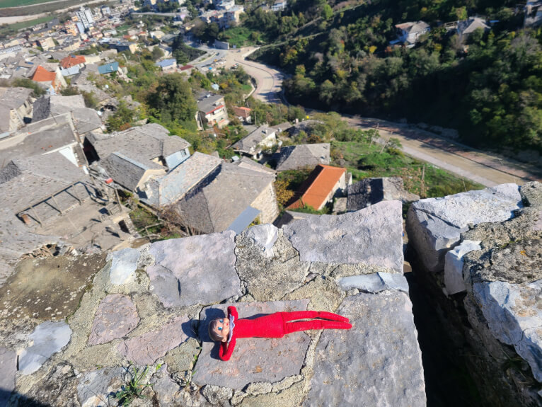 An elf on the shelf relaxes on the walls of Gjirokaster castle