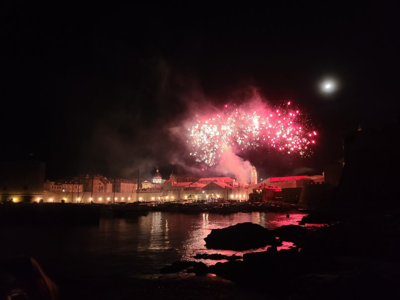 Red fireworks going off at midnight over the marina in old town Dubrovnik Croatia