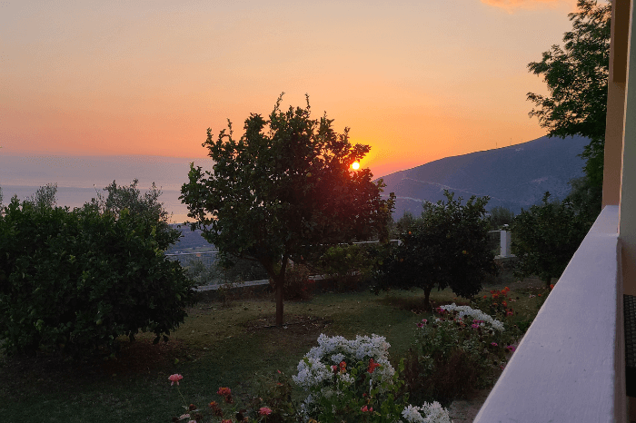 The sunset behind the hills above Borsh from Onirana apartments